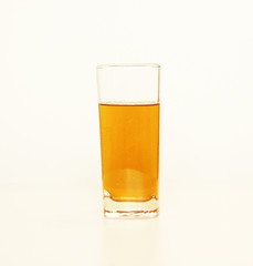 One glass of yellow and transparent liquid on white background, São Paulo, Brazil