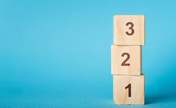 Wooden alphabet number blocks 123 on blue background