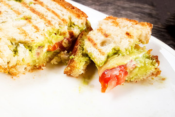Healthy breakfast toast with avocado and tomatoes smash, close up, on white plate. Mobile photography.