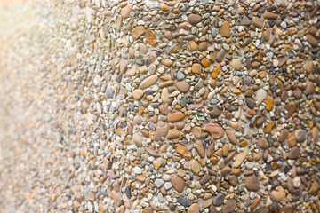 Texture of small white cobble stone. Sunlight blick. Copyspace, place for text