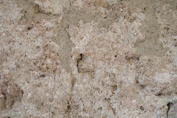 Fragment of an old brown wall. A fragment of an old clay wall in a background photo.
