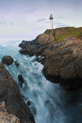 White pigeon point lighthouse with a blue sky  Historic Old Lighthouse at sunset - Pigeon Point Lighthouse - California, USA