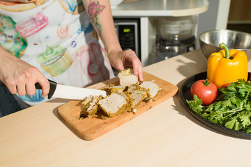 Girl cook cuts meat for a delicious tortilla