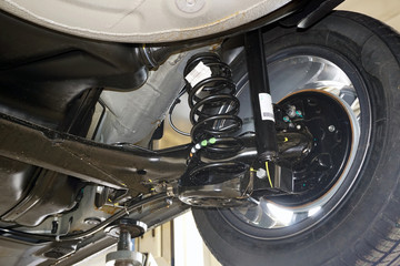 Rear suspension of a modern car. Elements and design of the rear suspension. Rear suspension beam,...