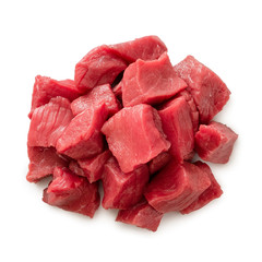 Pile of beef cubes isolated on white from above.