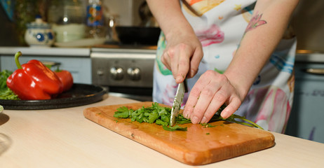 Girl cook makes cutting vegetables for tasty and juicy tortilla