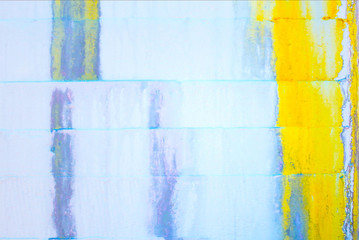 Abstract Grunge Background - white wall with yellow and blue dripping paint and large crack