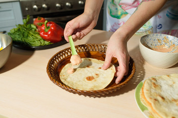 Girl cook cooks delicious tortilla pork and fresh vegetables