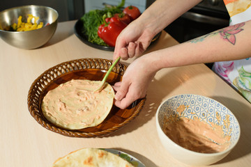 Girl cook cooks delicious tortilla pork and fresh vegetables