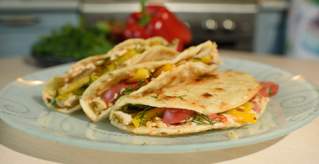 Tasty and juicy tortilla on a glass plate close up