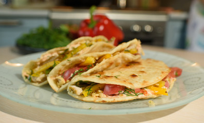 Tasty and juicy tortilla on a glass plate close up