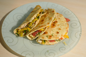 Tasty and juicy tortilla on a glass plate close up