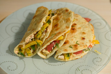 Tasty and juicy tortilla on a glass plate close up