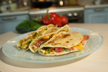 Tasty and juicy tortilla on a glass plate close up