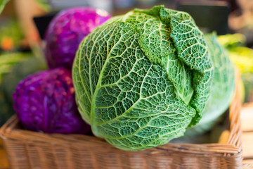 Savoy cabbage super food close up, on farmer market, against the background purple cabbage