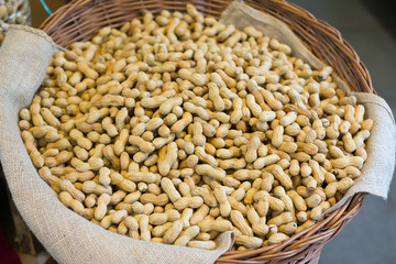 Peanuts in shell texture background. Raw peanuts on display at a farmer's market. Close up image.