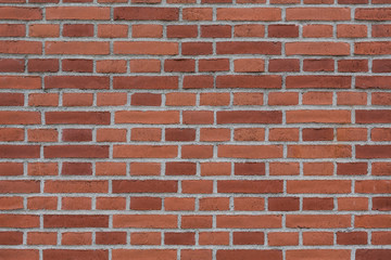 Empty brickwork background. Wallpapers of stable masonry. Rough surface. The texture of the surface is a dark red brick work.