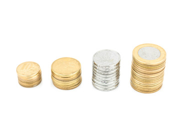 Close-up Brazilian currency money, white background. Coins of savings. Brazil. Selective focus. Growing business and future concept, coins stack.