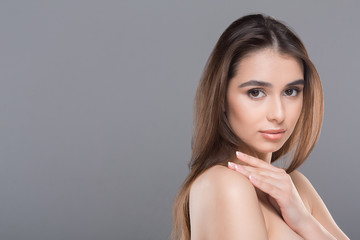 Naklejka premium Perfect beautiful woman caressing her smooth shoulder