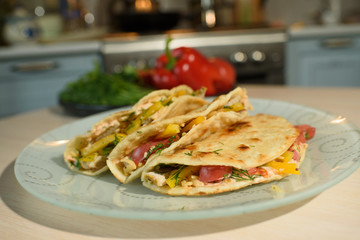Tasty and juicy tortilla on a glass plate close up