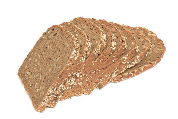 Loaf of fresh sliced multigrain gluten free bread with sesame, flax seeds, isolated on white. side view