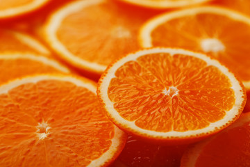 Slices of ripe orange backlit as a textural background. Full screen, close-up, macro