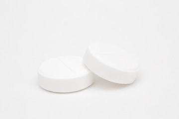 White pills closeup isolated on white background