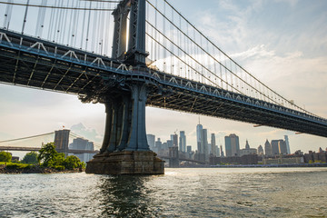 Fototapeta na wymiar Manhattan Bridge and buildings on East river side view from Brooklyn