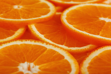 Slices of ripe orange backlit as a textural background. Full screen, close-up, macro