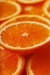 Slices of ripe orange backlit as a textural background. Full screen, close-up, macro