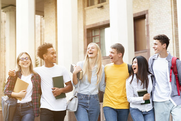 Fototapeta premium Happy students walking together in campus, having break