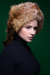 seasonal fashion, Portrait of beautiful young female  model, blue eyed girl wearing fur hat
