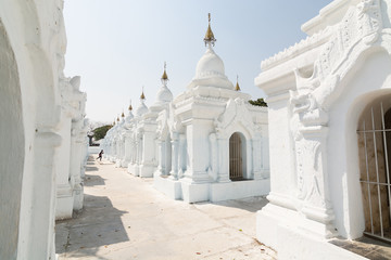 Obraz premium Burmese boy running among stupas of Kuthodaw Pagoda in Mandalay, Myanmar