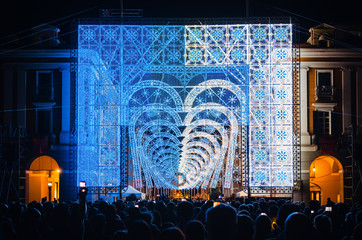 Crowd looking a light and music performance at night during Cuneo Illuminata (Illuminated Cuneo),...