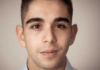 Fototapeta premium Portrait of handsome young man in neutral poker facial expressions and human emotions