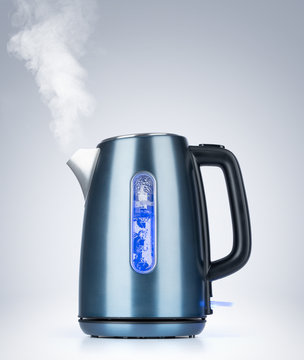 Boiling Electric Kettle Gives Off Steam On Background 