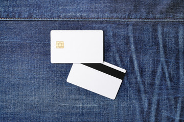 Two blank credit cards on denim background. Chip cards. Mockup for branding identity. Template for graphic designers portfolios. Flat lay.