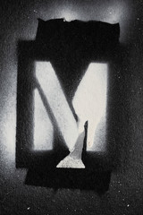 Letter M grunge spray paninted stencil font