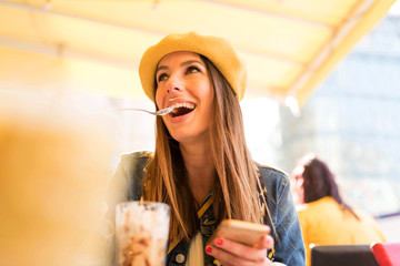 A young woman enjoying her ice coffee.