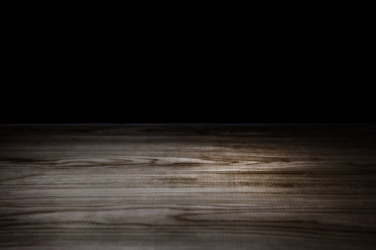 table top Dark wooden. Table isolated on Black background can be used for display or montage your products .