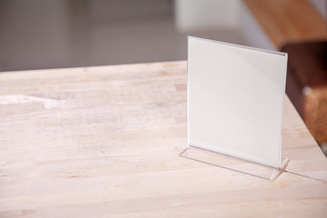 White label on the table. Stand for acrylic tent card Used for Menu Bar and restaurant or put everything into it . mockup