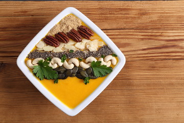 Pumpkin smoothie in a white bowl.