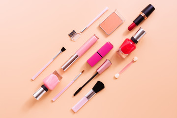 Set of female cosmetics makeup on a pink pastel background. Flat lay, top view, copy space.