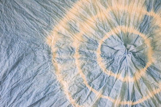 Light sky blue tie dye with white circle pattern. Indigo dyeing fabric. Textile pattern. Craft and handmade dyeing farbic with rope typing techinque.