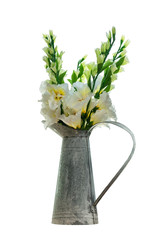 A bouquet of white plastic flowers is placed in a zinc vase