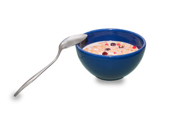 Spoon and Bowl of oatmeal porridge with banana, blueberries, almonds, coconut and caramel