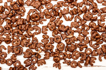 Dry cereal breakfast in the form of letters of the English alphabet on a white background.