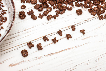 dry cereal breakfast laid out by the word breakfast on a white wooden background.