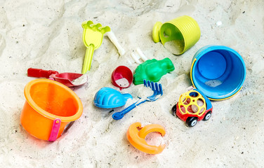 Fototapeta na wymiar Children's colored plastic toys in the sandbox