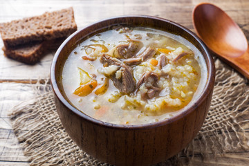 Kharcho soup with meat and rice on wooden table